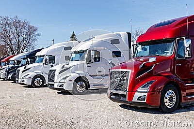 Colorful Volvo Semi Tractor Trailer Trucks Lined up for Sale. Volvo is one of the largest truck manufacturers V Editorial Stock Photo