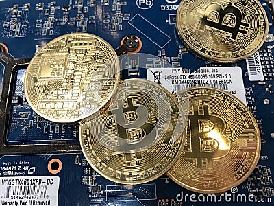 A Pile of Bitcoins and a GPU Editorial Stock Photo
