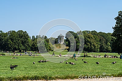 Munich, Germany - Jul 28, 2021: The English Garden in Munich, Germany overflowing with young people Editorial Stock Photo