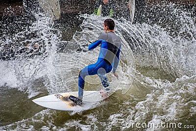 Munich, Germany - July 13, 2021: Surfer in the city river Eisbach. Munich is famous for surfing in urban enviroment Editorial Stock Photo