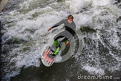 Munich, Germany - October 13, 2023: Surfer in the city river called Eisbach at Munich, Germany Editorial Stock Photo