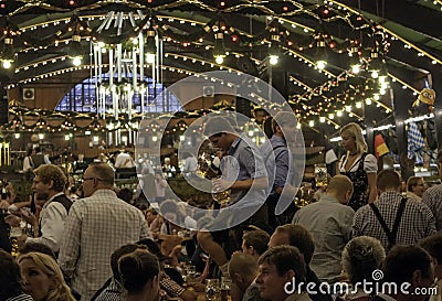 MUNICH, GERMANY - SEPTEMBER 18, 2016: Oktoberfest munich: People in traditional costumes in the beer pavilion Editorial Stock Photo