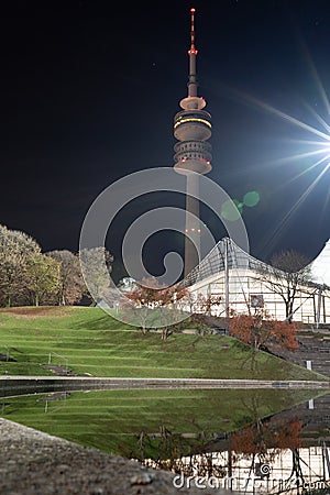 Munich olympic TV tower situated in Olympiapark on a clear night with heavy lensflare. Stock Photo