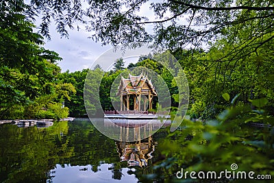 Munich Westpark Pagoda reflecting in the water with the trees in the background Stock Photo