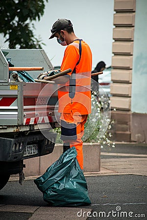 Municipal employee wearing orange vest working in the street Editorial Stock Photo