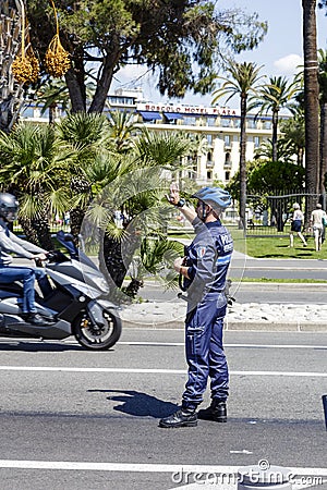 Municipal Policeman directs traffic in Nice Editorial Stock Photo