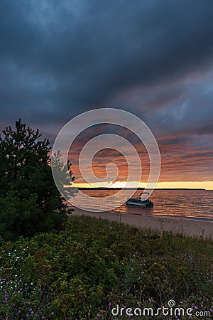 Munising Michigan, USA - August 11, 2021: Pontoon boat anchored near a beach Editorial Stock Photo