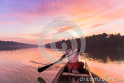 Canoe oarsman taking us on an early morning tour amidst serenely beautiful ashtamudi lake Editorial Stock Photo