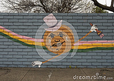 Mural on a barrier wall between Forest Lane and the neighborhood on the North side, painted in 1976 by art students. Editorial Stock Photo