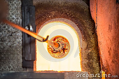 Murano glass-blowing factory. Glass blower forming beautiful pie Stock Photo