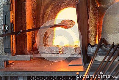 Murano glass-blowing factory. Glass blower forming beautiful pie Stock Photo