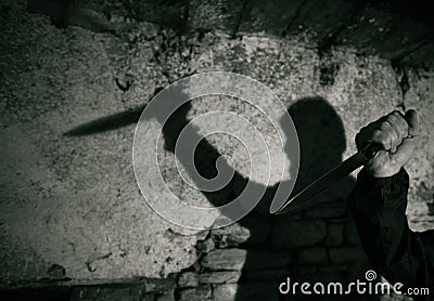 murderer with big knife and shadow horror scene Stock Photo