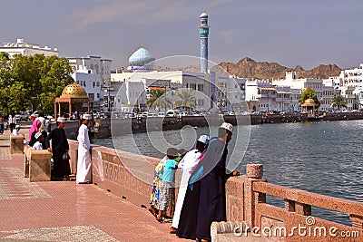 MUSCAT, OMAN - FEBRUARY 10, 2012: Muttrah corniche in Muscat with Omani young boys traditionally dressed Editorial Stock Photo