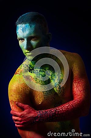 Muscle man with fantasy body art Stock Photo
