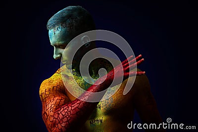 Muscle man with fantasy body art Stock Photo