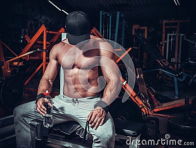 Muscle shaped man tired sitting relaxed Stock Photo