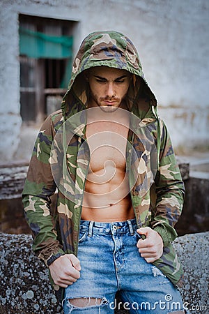 Muscled boy with camouflage jacket Stock Photo