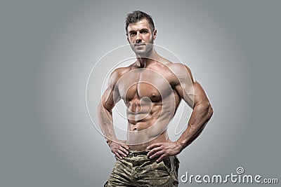 Muscular athlete bodybuilder man on a gray background Stock Photo