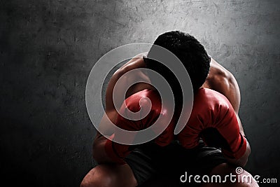 Muscular boxer resting on wall backgrounds Stock Photo