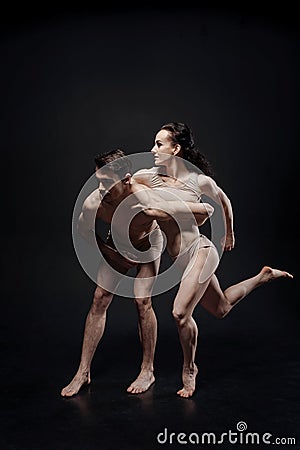 Muscular gymnasts performing together in the studio Stock Photo