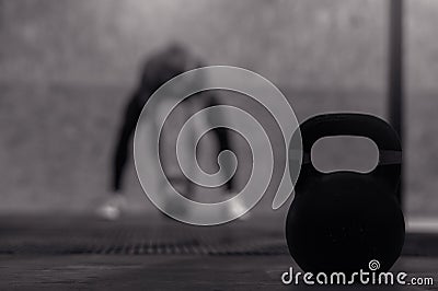 Muscular male adult exercising with kettle bell Stock Photo