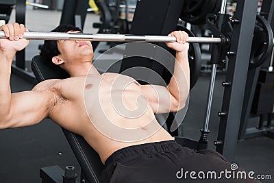 Muscular male having pain on shoulder in gym. young man injure Stock Photo