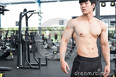 Muscular male having pain on shoulder in gym. young man injure Stock Photo