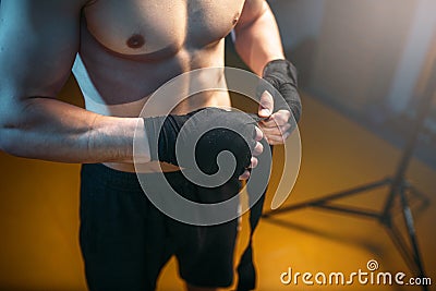 Muscular male person hands in black bandages Stock Photo
