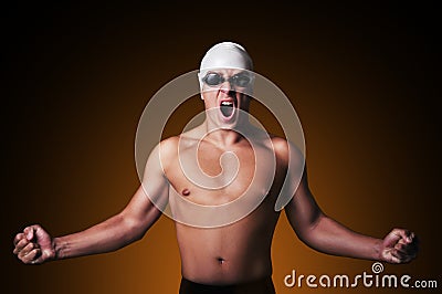 Muscular male swimmer with clenched fist is celebrating Stock Photo
