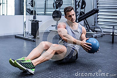 Muscular man doing russian twist exercises Stock Photo