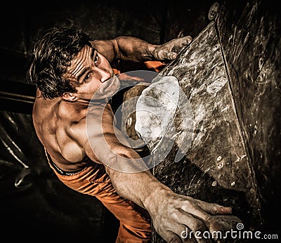 Muscular man practicing rock-climbing Stock Photo