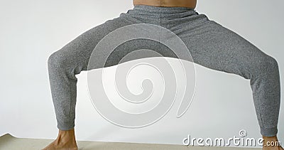 Muscular man is standing with lifted hands, tensing muscles of body and meditating with closed eyes Stock Photo