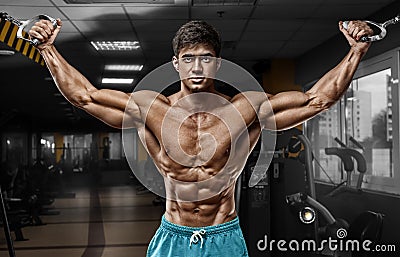 Muscular man working out in gym doing exercises, strong male naked torso abs Stock Photo