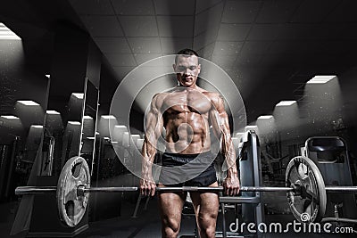 Muscular man workout with barbell at gym. Deadlift barbell work Stock Photo