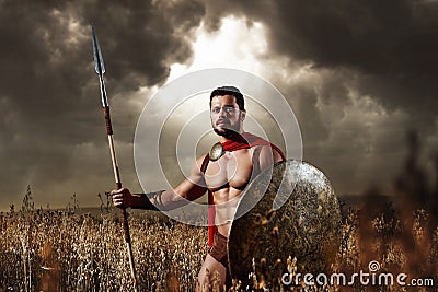 Muscular medieval warrior standing in the field Stock Photo