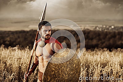 Muscular medieval warrior standing in the field Stock Photo