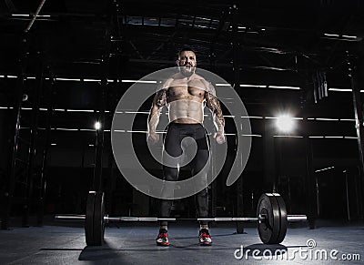 Muscular shirtless man concentrating before the barbell workout. Stock Photo