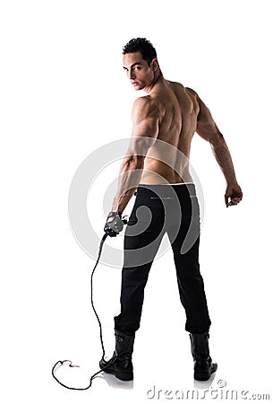 Muscular shirtless young man with whip and studded glove Stock Photo