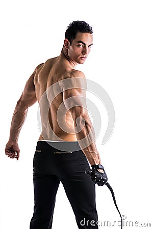 Muscular shirtless young man with whip and studded glove Stock Photo