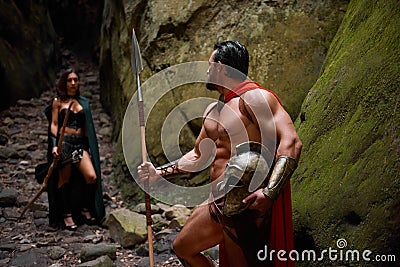 Spartan warrior and his woman in the woods Stock Photo