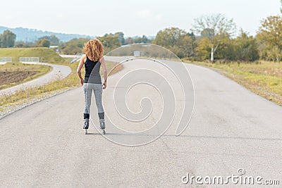 Muscular sporty young woman on roller blades Stock Photo