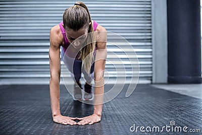 Muscular woman doing press up exercises Stock Photo