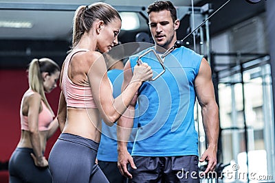 Muscular woman doing pulling exercises Stock Photo