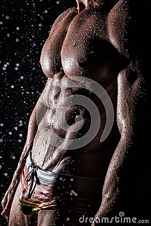 Muscular young athletic guy under the rain Stock Photo