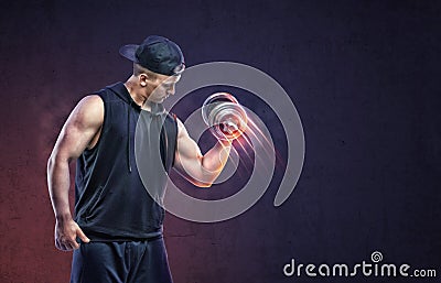 Muscular young guy lifting a dumbbell to training his biceps. Stock Photo