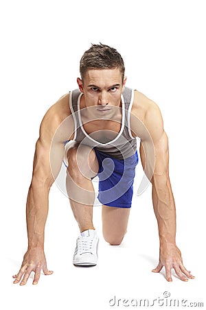 Muscular young man ready to race in sports outfit Stock Photo