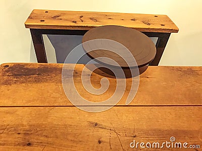 Museum piece. ancient machine for pottery natural wood. circle for modeling clay products. table and seat for a person working Editorial Stock Photo