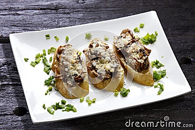 Mushroom bruschetta and grated parmesan Stock Photo