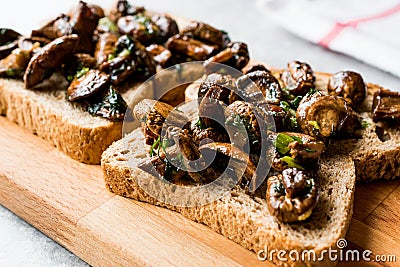 Mushroom Bruschetta Toast Sandwich on Wooden Surface. Stock Photo