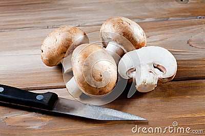 Mushrooms on wood, knive, chopped Stock Photo